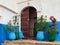 Traditional Moroccan door with cats resting in front in Oudayas Kasbah in Rabat, Morocco