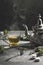 Traditional Moroccan teapot with a steaming cup of tea in a smoky black atmosphere. Vertical format