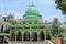 Traditional mosque with lush green facade on Java island in Indonesia. A spiritual place to meet Muslim believers for prayer.