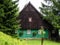 Traditional mountain chalet, natural brown and green front