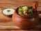 Traditional Murgh dum Biryani made of Basmati rice cooked with masala spices, served with yogurt on traditional clay pot,