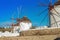 Traditional Mykonos windmill against a blue sky