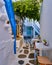 Traditional narrow cobbled streets, beautiful lanes of Greek island towns. Whitewashed houses, cafes, tables, chairs