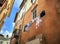 Traditional narrow street and old houses with washing hanging in