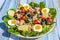 Traditional Nicoise Salad on a blue wooden background. Salad ingredients Tuna, Eggs, Potatoes, Green Beans, Cherry Tomatoes and