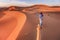 Traditional nomadic clothing and transportation by camel in the Sahara Desert.