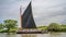 Traditional Norfolk wherry Albion sailing down the River Bure in Horning, UK