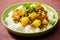 Traditional North Indian dish Aloo Matar potatoe and green peas curry served with rice. Hearty vegetarian meal healthy diet