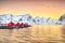 Traditional Norwegian red wooden houses rorbuer on the shore of  Reinefjorden near Hamnoy village at sunset