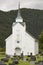 Traditional norwegian white wooden church. Fortun village. Travel Norway.