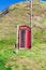 Traditional old British Telecom red phone box in Crovie, Aberdeenshire, Scotland