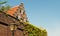 A traditional old Dutch house with a staircase roof and orange tiles