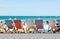 Traditional old fashion wooden deck chairs along promenade in Weymouth