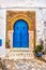 Traditional old painted door in a historical district or medina, Tunisia.