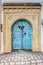 Traditional old painted door in a historical district or medina, Tunisia.