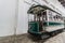 Traditional old Portuguese green tram in the depot. Perspective view of vintage wagon with open driver cockpit