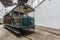 Traditional old Portuguese green tram in the depot. Perspective view of vintage wagon with open driver cockpit and copper lantern