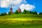 Traditional old Russian Church - summer landscape with blue sky, green hills with grass