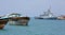 Traditional old style wooden fishing and cargo ships and EU WARSHIP F-262
