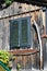 Traditional old wooden austrian house in the city of Hallstatt, Austria. Window, agricultural tools on a wooden wall. Travel