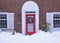 Traditional older brick house with colorful wreath on front door