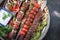 Traditional oriental adana kebap and shashlik skewer with tomato and flatbread on a plate