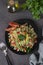 Traditional oriental salad Tabouleh with bulgur and parsley on brown background, Top view