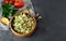 Traditional oriental salad Tabouleh with couscous or bulgur on adark concrete background.