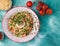 traditional oriental taboule salad on a blue background next to the ingredients