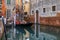 Traditional ornate venetian gondola docked in a picturesque canal in Venice, Italy