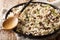 Traditional Orzotto perlotto with forest porcini mushrooms and thyme closeup on a plate. horizontal