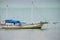 Traditional outrigger boat anchored at Labuan Bajo town on Flores Island, Nusa Tenggara, Indonesia