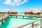 Traditional over water villas on a tropical lagoon of Bora Bora