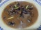 Traditional Pakistani Haleem served with green salad and Lemon juice on a table