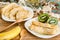 Traditional pancakes on white plate with bananas and kiwi