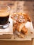 Traditional pastries, Italian homemade biscotti cookies or cantuccini, with almonds nuts and coffee. Wooden background