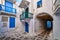 Traditional patio or dead end in narrow streets of Greek towns on Cyclades. Authentic whitewashed walls, blue doors and