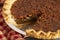 A Traditional Pecan Pie with a Slice Cut Out