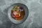 Traditional peruvian food ceviche from seabass. Close-up, low key, gray background. Top view copy space