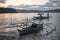 Traditional Philippino fishermen returning home on their boats to a bay during sunset in El Nido Palawan the Philippines