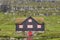 Traditional picturesque faroe islands wooden house with green roof