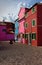 Traditional pink, bordeau and blue houses in Burano, Venice, Italy