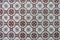 Traditional porcelain azulejo ceramic tile in brown colors on th