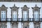 Traditional Porto Portugal building exterior with windows and ornate balconies with a white facade