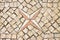 Traditional portuguese floor made of small pieces of stone with navigational compass icon