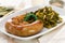 Traditional portuguese smoked sausage with turnip greens on white plate