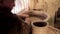 Traditional pottery making, close up of potter`s hands shaping a bowl on the spinning by clay