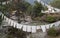 Traditional prayer Tibetan Buddhist flags Lung Ta over the river in Bhutan in the Thimphu River valley.