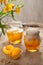 Traditional preserved peaches compote with juice in glass jars