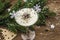 Traditional prune dessert with nuts and whipped sour cream with sugar. New Year`s sweet treat concept. Wooden boards background